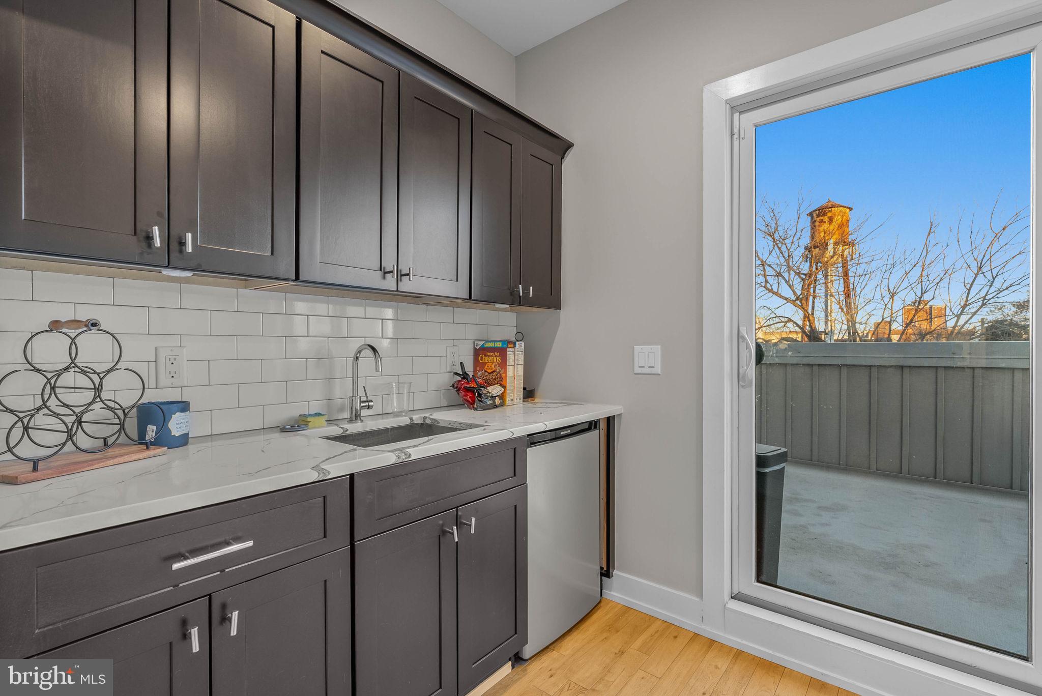 1517 North 27th Street Philadelphia, PA 19121 - Photo 30 of 31 a kitchen with stainless steel appliances granite countertop a sink a stove and cabinets