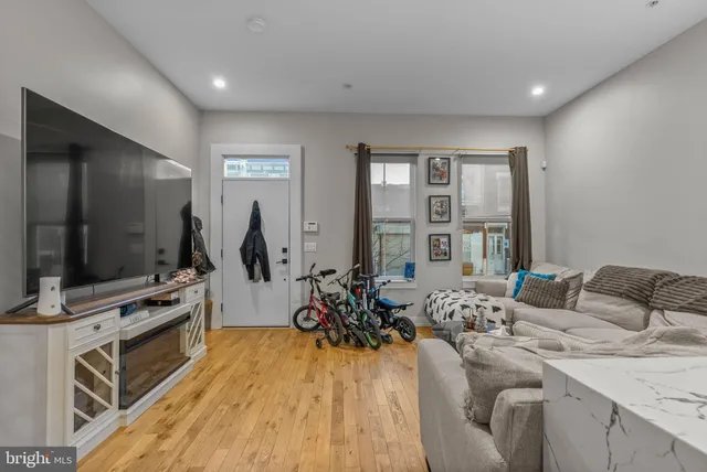 a living room with furniture and flat screen tv