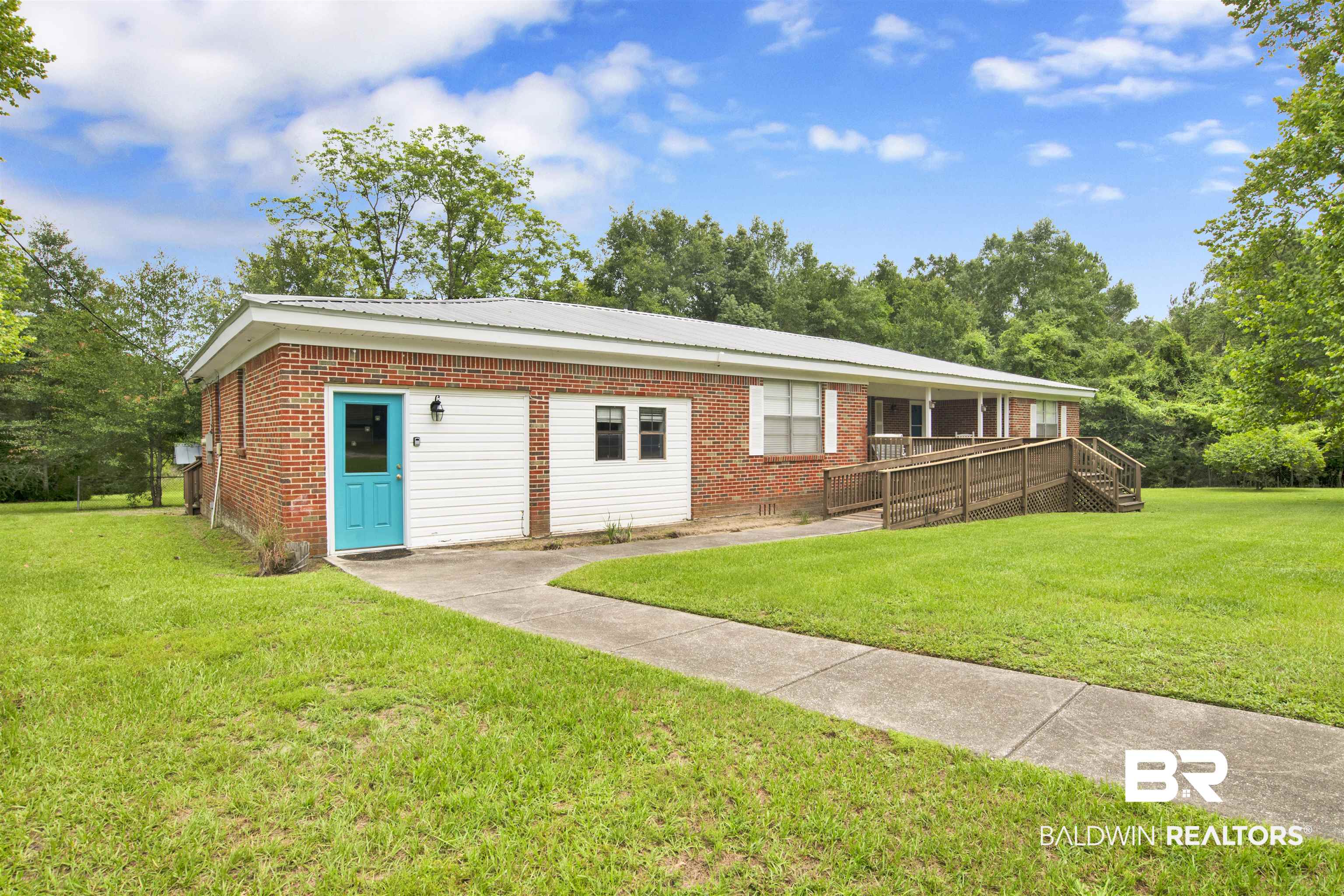 17714 Horseneck Road Bay Minette, AL 36507 - Photo 16 of 36 Brick exterior with white siding accents and a metal roof
