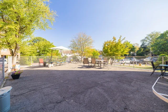 a view of a street with a building and trees in the background