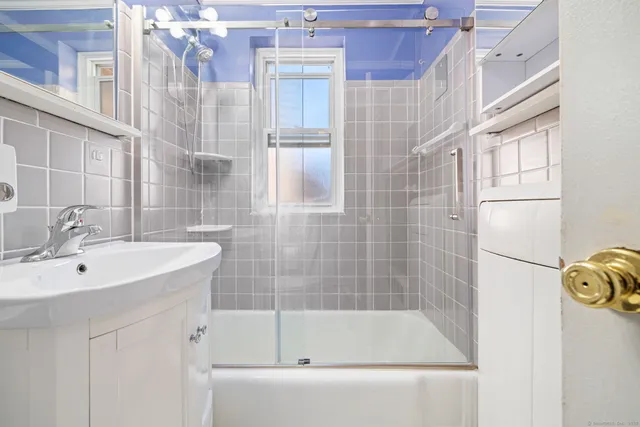 a bathroom with a bathtub and shower