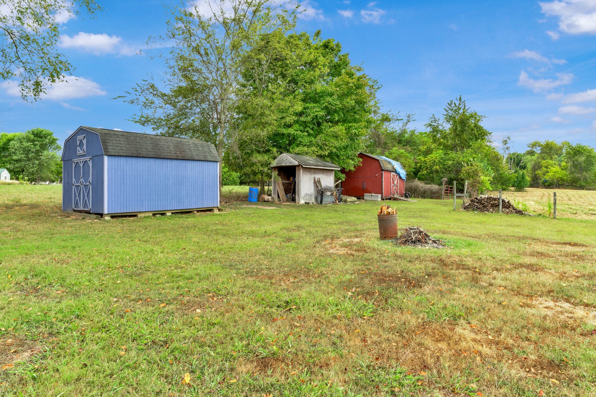 1584 Errel Dowlen Road Pleasant View, TN 37146 - Photo 24 of 28 a backyard of a house with table and chairs plants and large tree