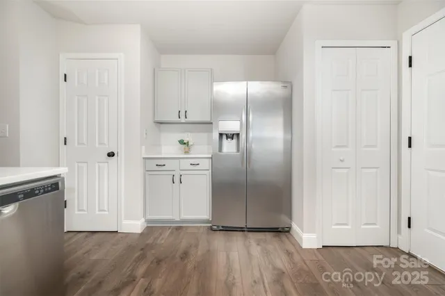 a view of kitchen with wooden floor electronic appliances and window