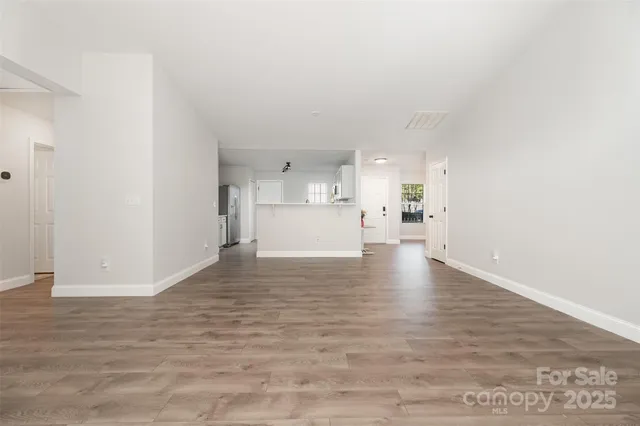 a view of a kitchen with a sink and a refrigerator