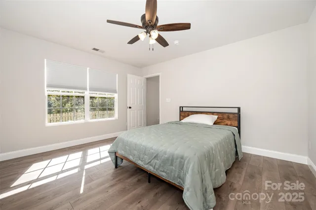 a bedroom with a bed and a large window