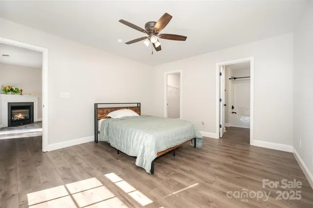 a bedroom with a bed and a ceiling fan