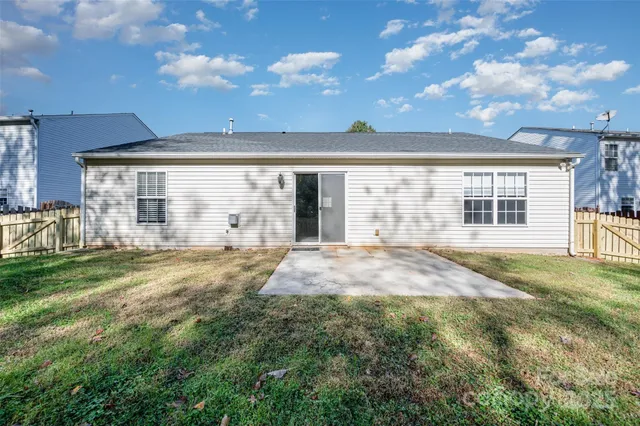 a view of an house with backyard and porch
