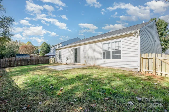 a backyard of a house with table and chairs