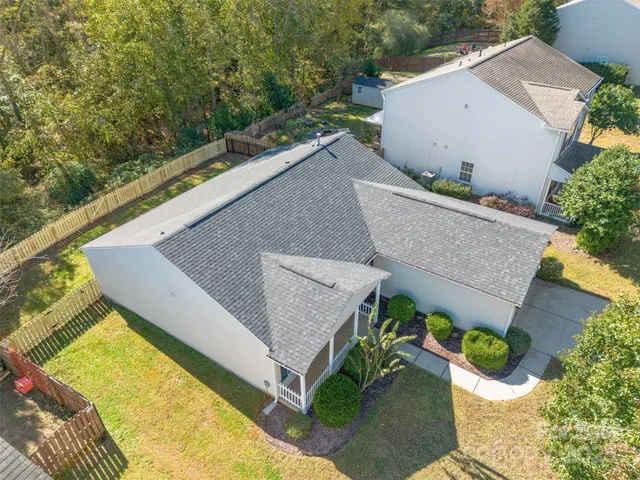 aerial view of a house with pool and a patio