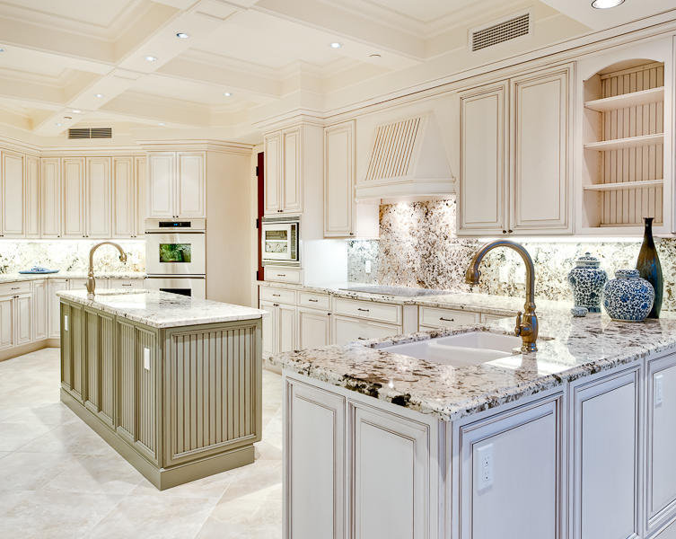 120 Jupiter Key Road, Unit PH 4 Jupiter, FL 33477 - Photo 6 of 20 a kitchen with kitchen island granite countertop a sink stove and cabinets