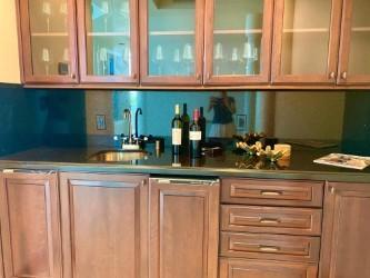 120 Jupiter Key Road, Unit PH 4 Jupiter, FL 33477 - Photo 8 of 20 a kitchen with a sink and wooden cabinets