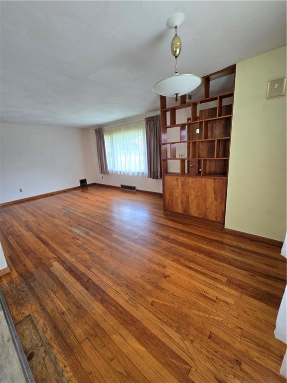 472 Portman Road Butler, PA 16002 - Photo 11 of 30 wooden floor in an empty room with a window