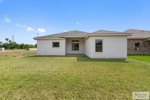 a view of a house with a backyard