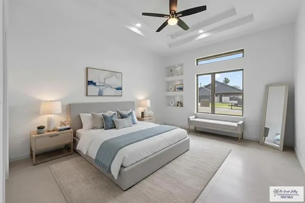 a bedroom with a bed couch and a window