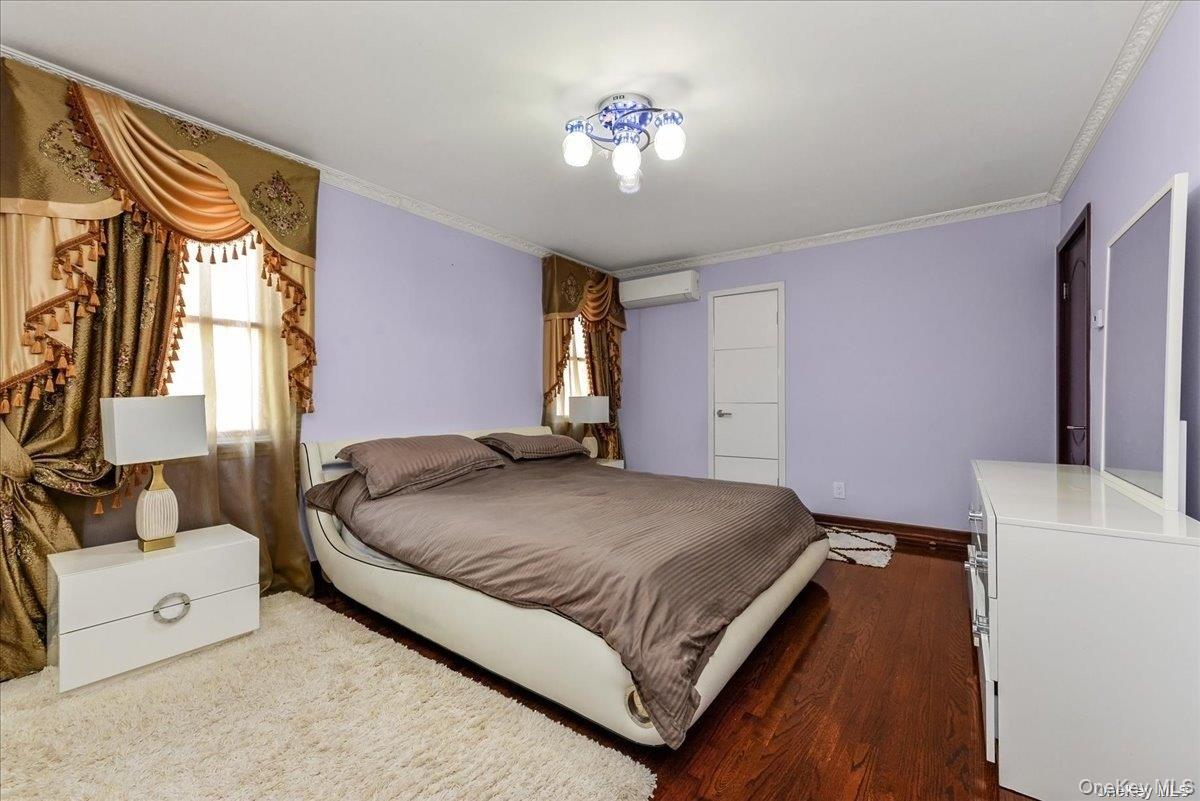 87-67 Chevy Chase Street Queens, NY 11432 - Photo 12 of 22 a spacious bedroom with a bed and a couch