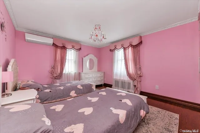 a bedroom with a bed dresser and a window