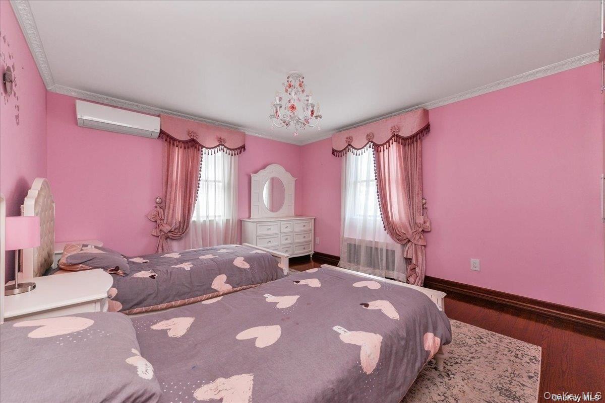 87-67 Chevy Chase Street Queens, NY 11432 - Photo 13 of 22 a bedroom with a bed dresser and a window