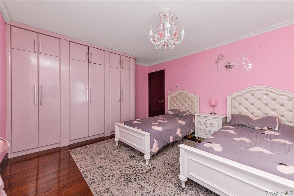 87-67 Chevy Chase Street Queens, NY 11432 - Photo 14 of 22 a living room with furniture and a chandelier