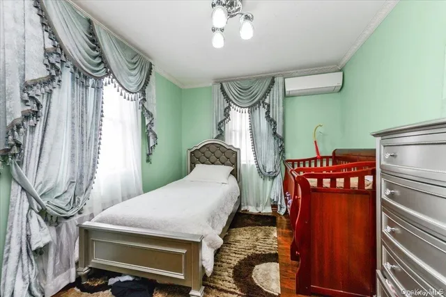 a bedroom with a bed and a chandelier
