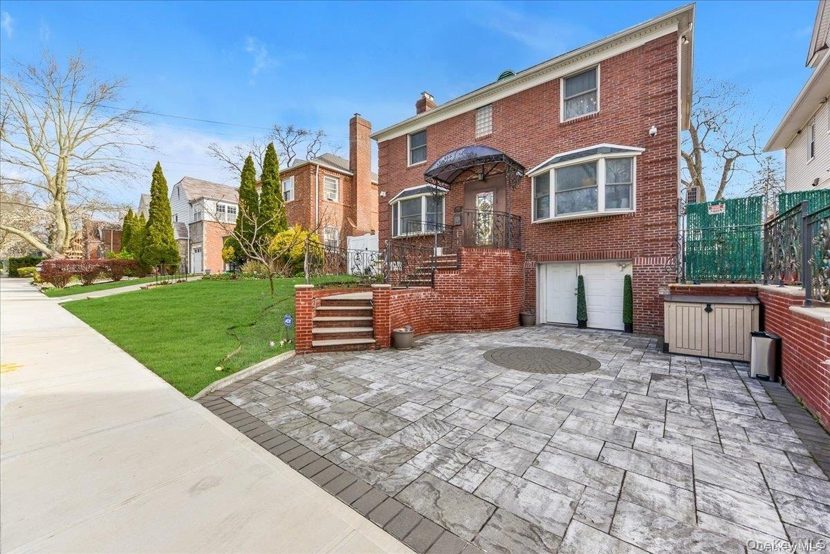 87-67 Chevy Chase Street Queens, NY 11432 - Photo 22 of 22 a front view of a house with garden