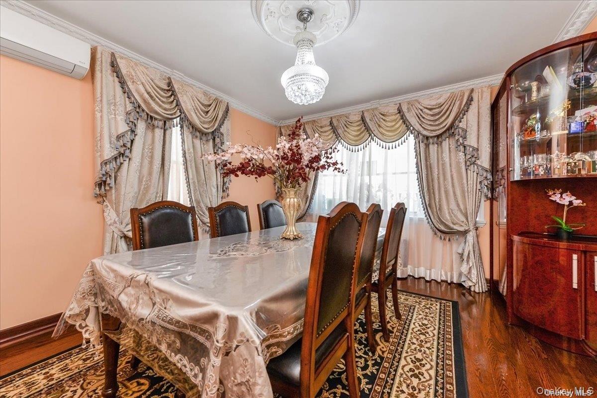 87-67 Chevy Chase Street Queens, NY 11432 - Photo 3 of 22 a view of a dining room with furniture and wooden floor