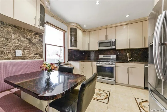 a kitchen with a stove a sink a microwave and dining table