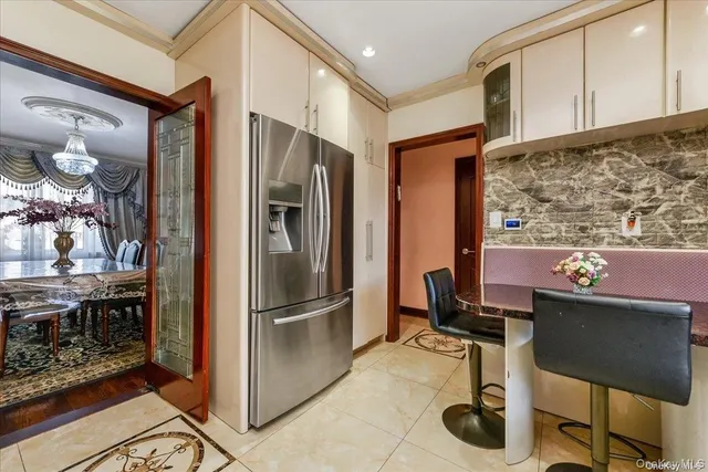a kitchen with stainless steel appliances kitchen island granite countertop a refrigerator and a stove top oven