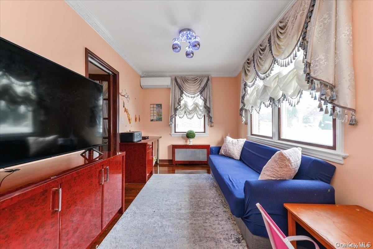 87-67 Chevy Chase Street Queens, NY 11432 - Photo 7 of 22 a living room with furniture and a flat screen tv
