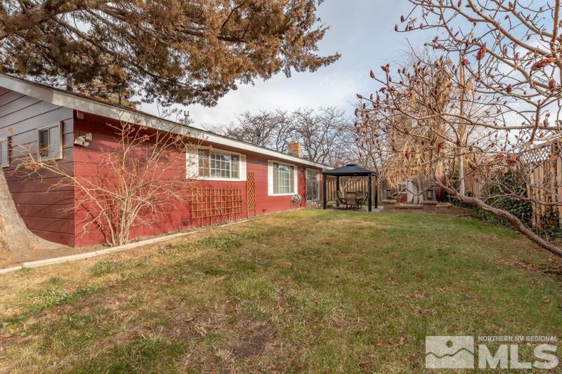 470 Tarn Way Reno, NV 89503 - Photo 17 of 18 a backyard of a house with a large tree