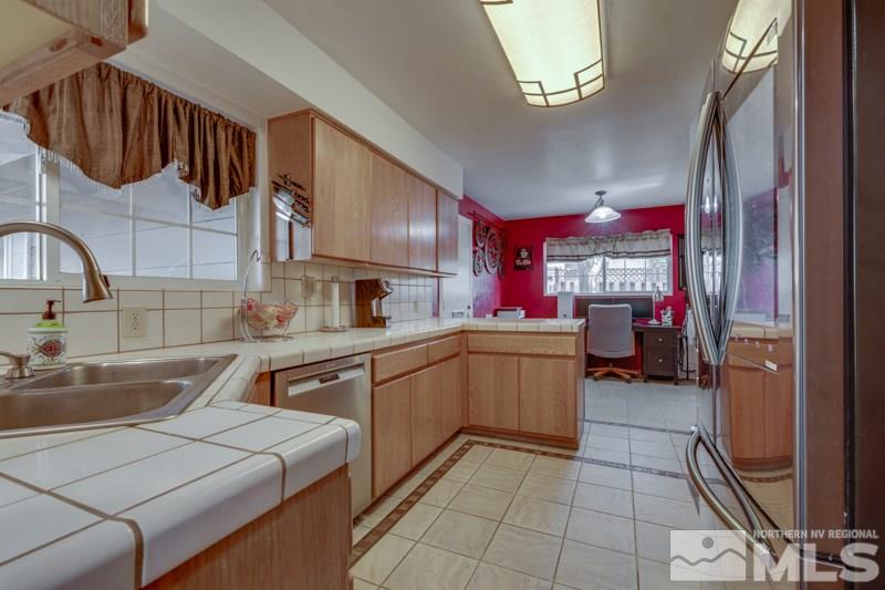 470 Tarn Way Reno, NV 89503 - Photo 5 of 18 a kitchen that has a sink and a stove in it