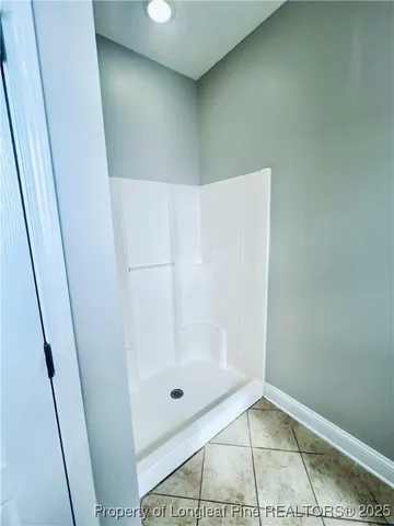 a bathroom with a glass shower door