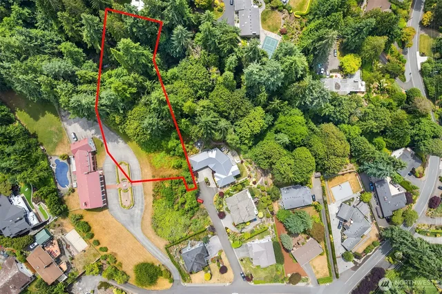 an aerial view of residential houses with yard