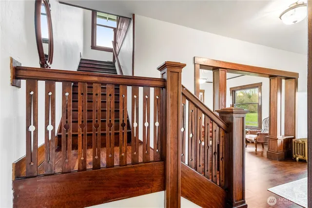 a view of staircase with lots of windows and wooden floor