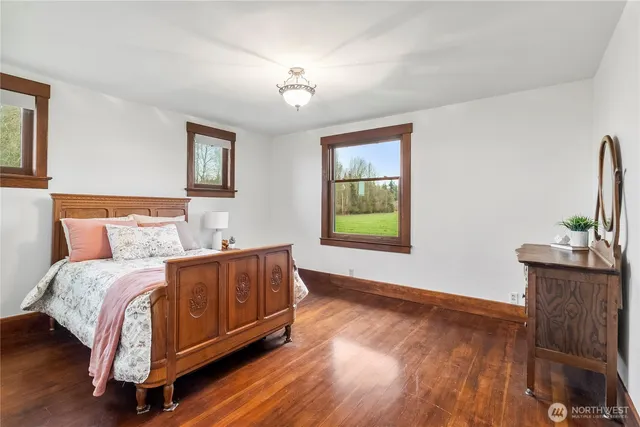 a spacious bedroom with a bed and a flat screen tv