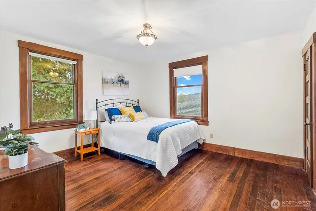 a bedroom with a bed chandelier and a window