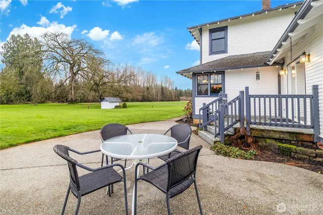 a view of a chair and table in the backyard