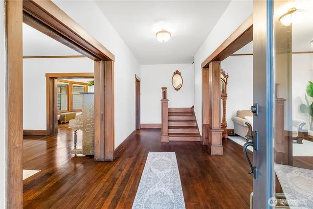 a view of a hallway view with wooden floor and staircase