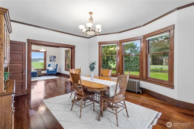 a view of a dining room with furniture wooden floor and chandelier