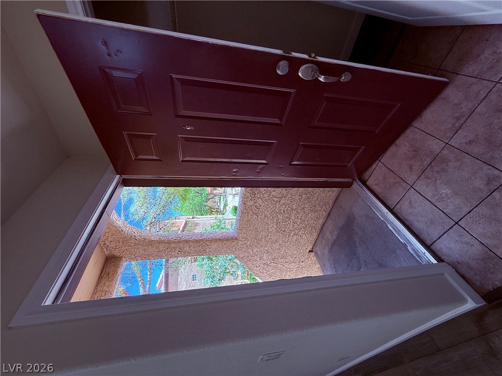 9325 West Desert Inn Road, Unit 260 Las Vegas, NV 89117 - Photo 17 of 42 Step through this open front door to a welcoming outdoor view.