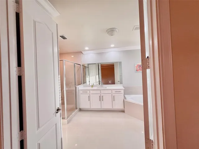 a large white room with kitchen view