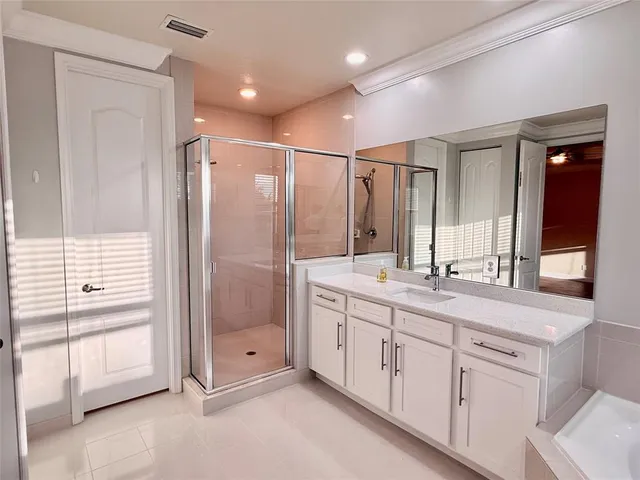a bathroom with a double vanity sink and mirror with shower