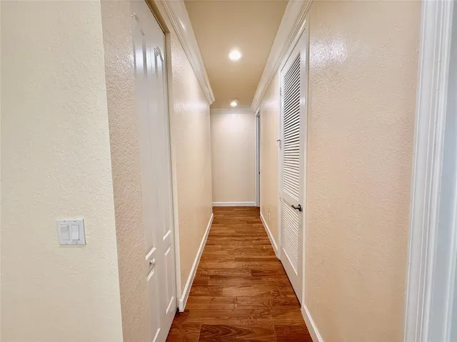 a view of a hallway with wooden floor