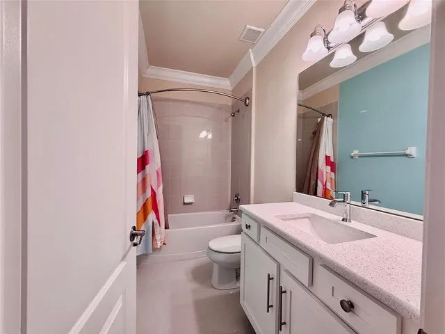 a bathroom with a sink vanity mirror and toilet