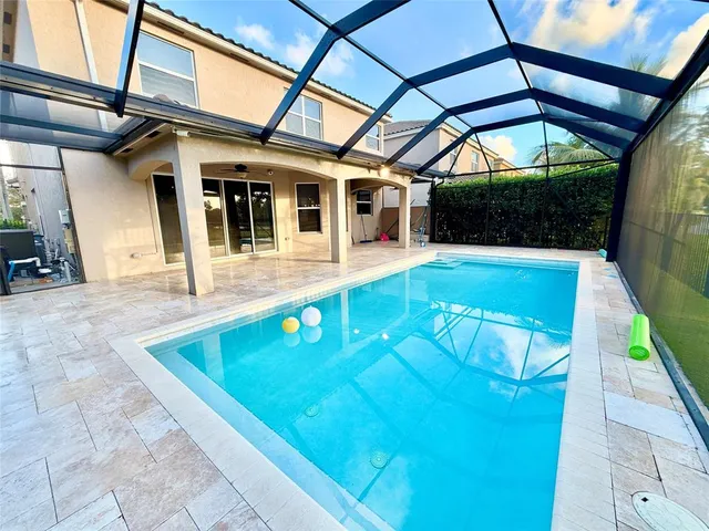 a view of a patio with a table and chairs under an umbrella