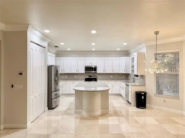a kitchen with a refrigerator and a stove top oven
