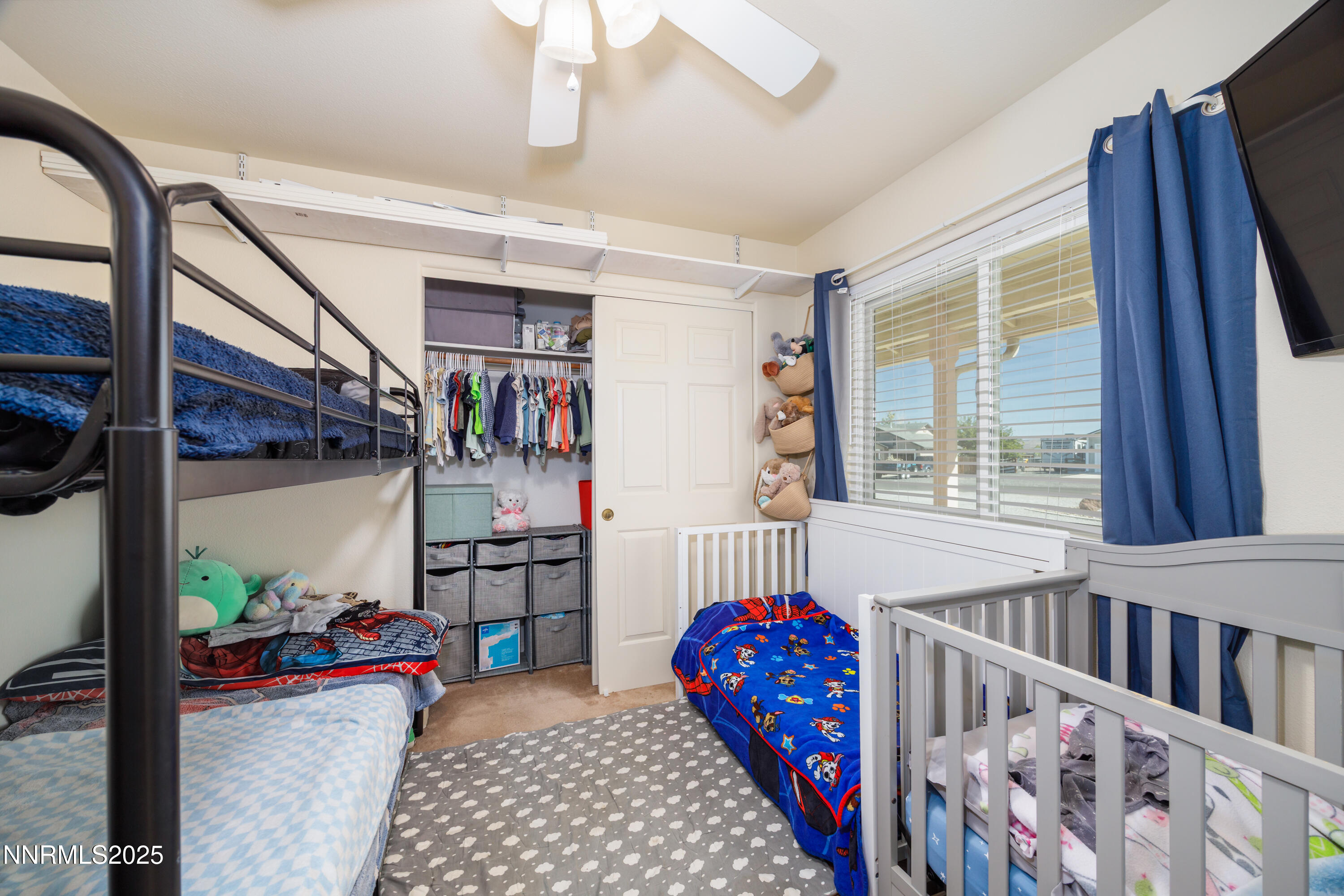 141 Country Ranch Road Fernley, NV 89408 - Photo 11 of 43 a bedroom with furniture a baby crib and a window