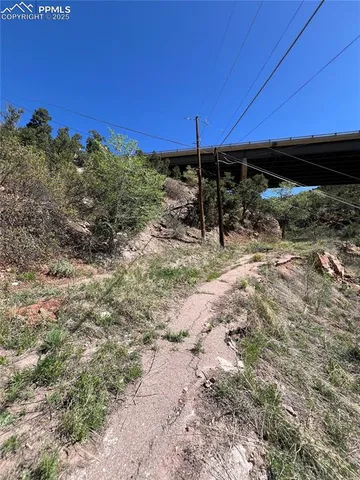 a view of a backyard with wooden fence