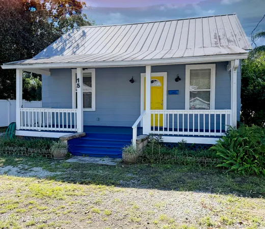 a view of a house with wooden deck and furniture