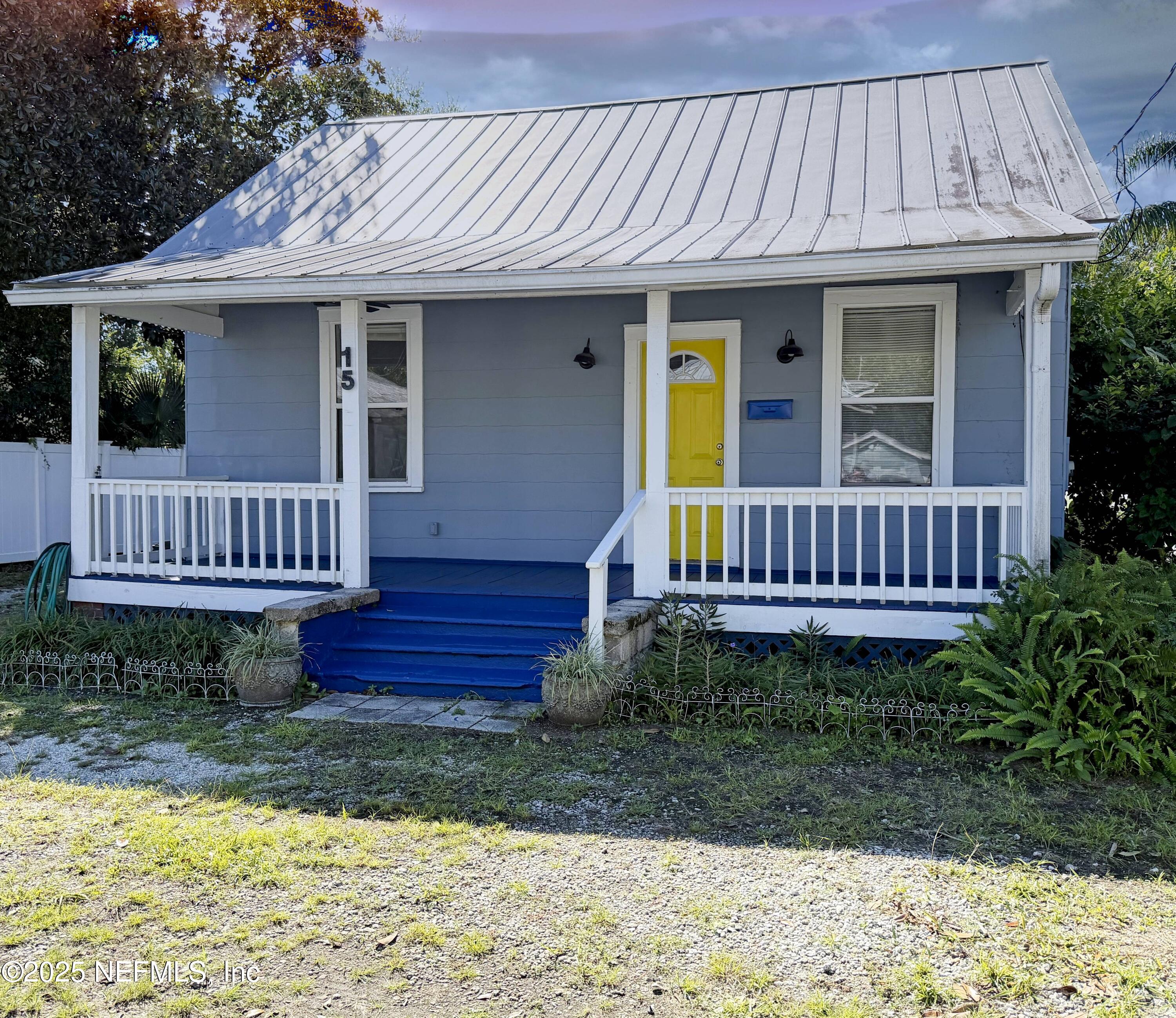 a view of a house with wooden deck and furniture