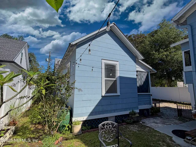 a view of a patio with table and chairs and potted plants